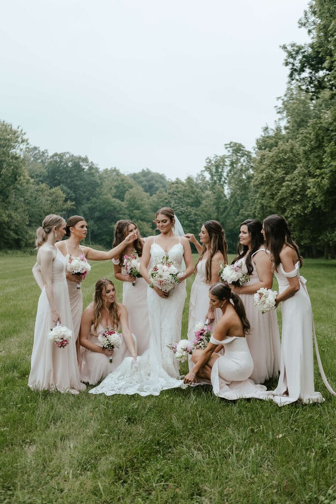 Bridesmaids surround bride and smile
