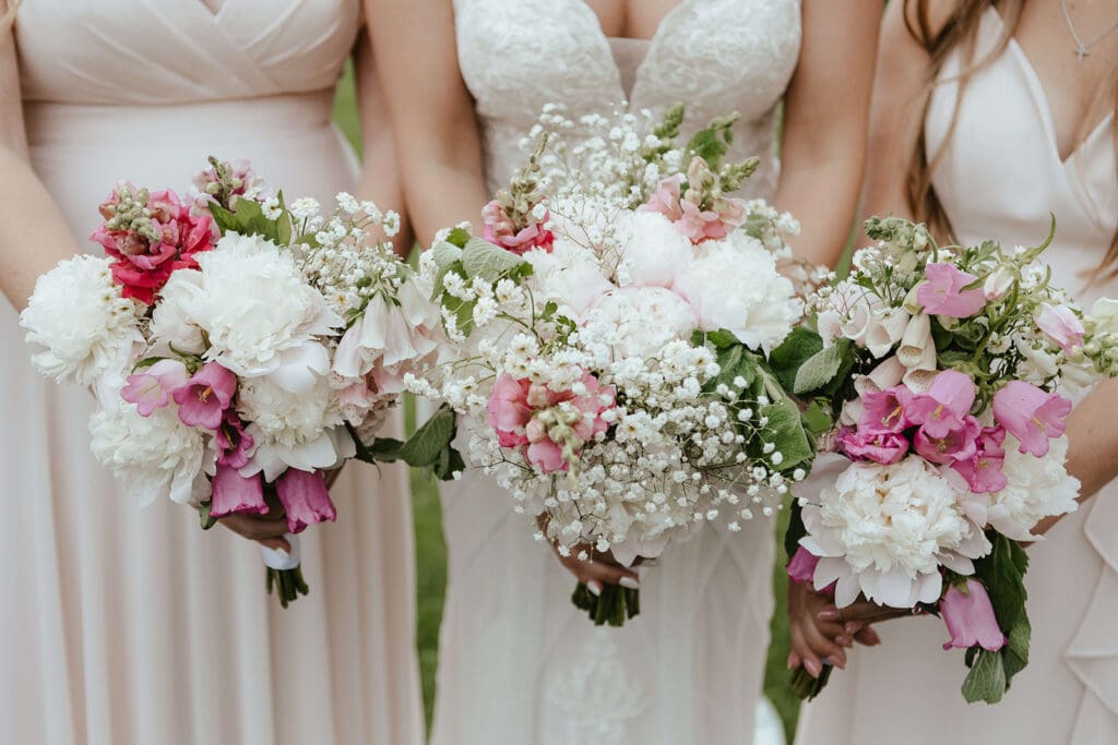 Close up detail of bridal bouquet and bridesmaids bouquets of pink and white flowers
