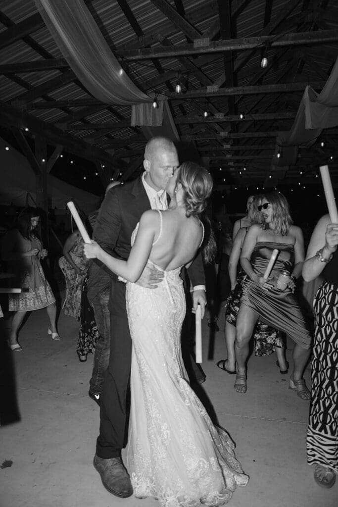 Bride and groom kiss on the dance floor during their wedding reception