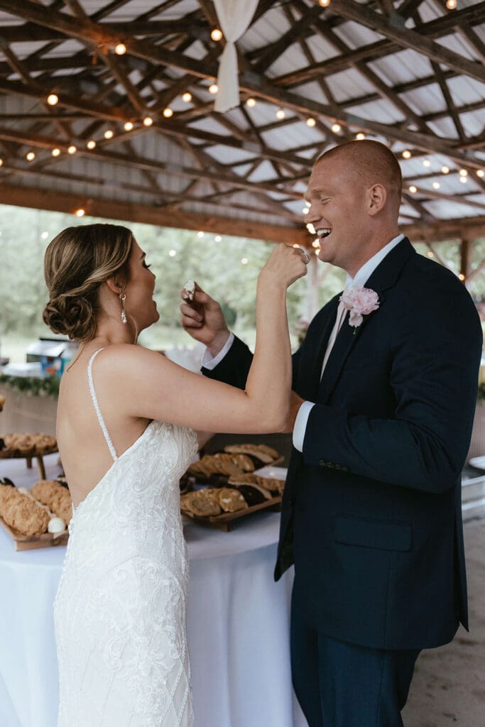 Bride and groom feed each other a piece of cake