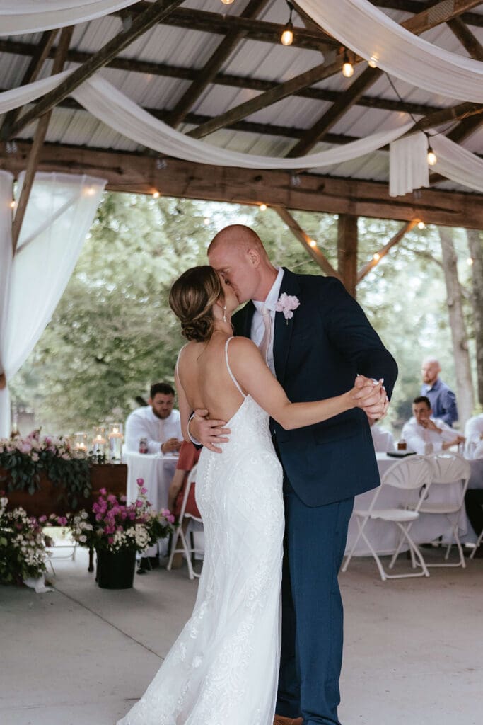 Bride and groom kiss during their first dance
