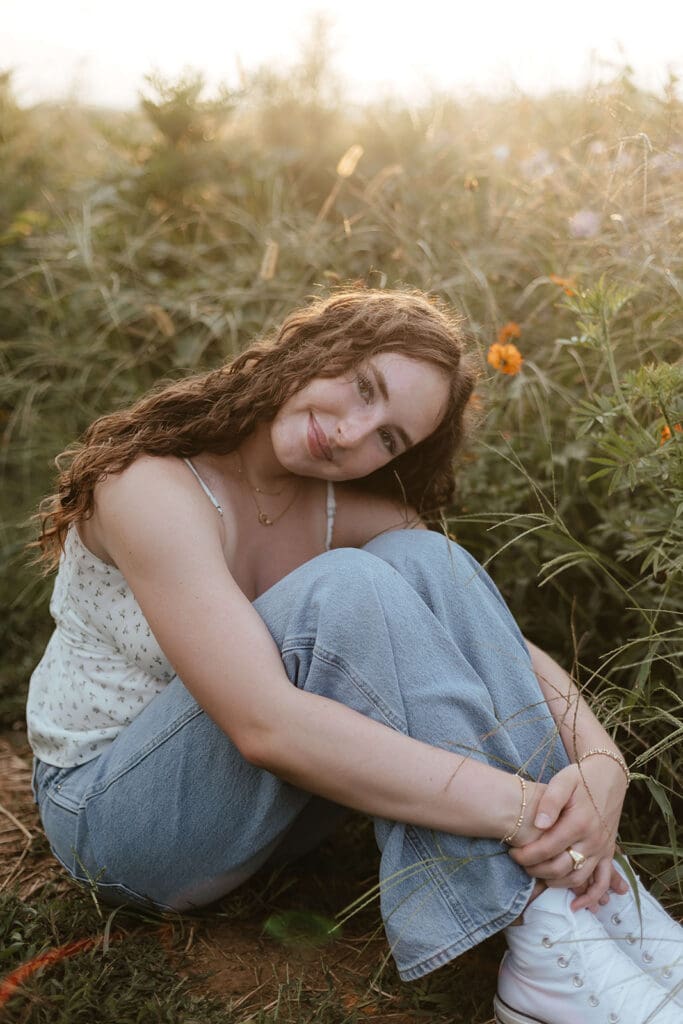 Girl sits and hugs knees at Wildflower Lookout in Lancaster, Pennsylvania