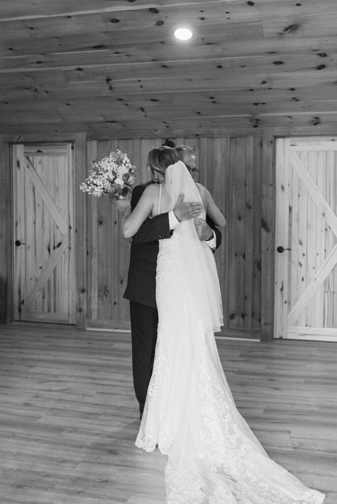 Bride hugs father after a first look