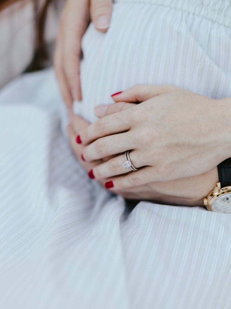 Man and woman touch woman's pregnant belly