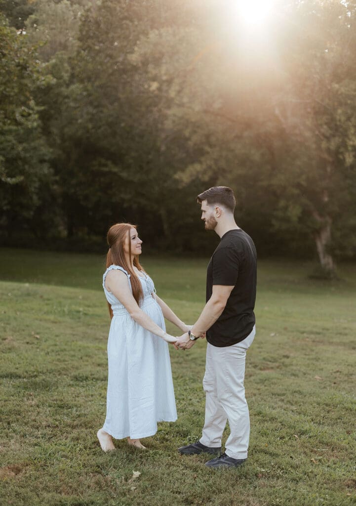 Man and woman hold hands as they gaze into each other's eyes