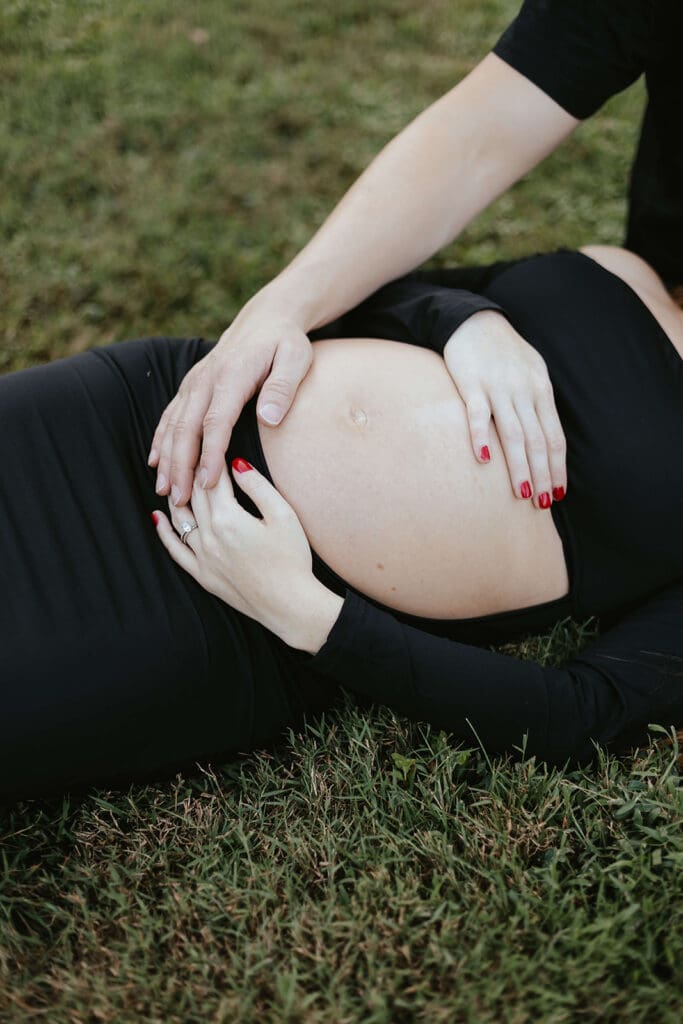 Close up of hands embracing a pregnant belly