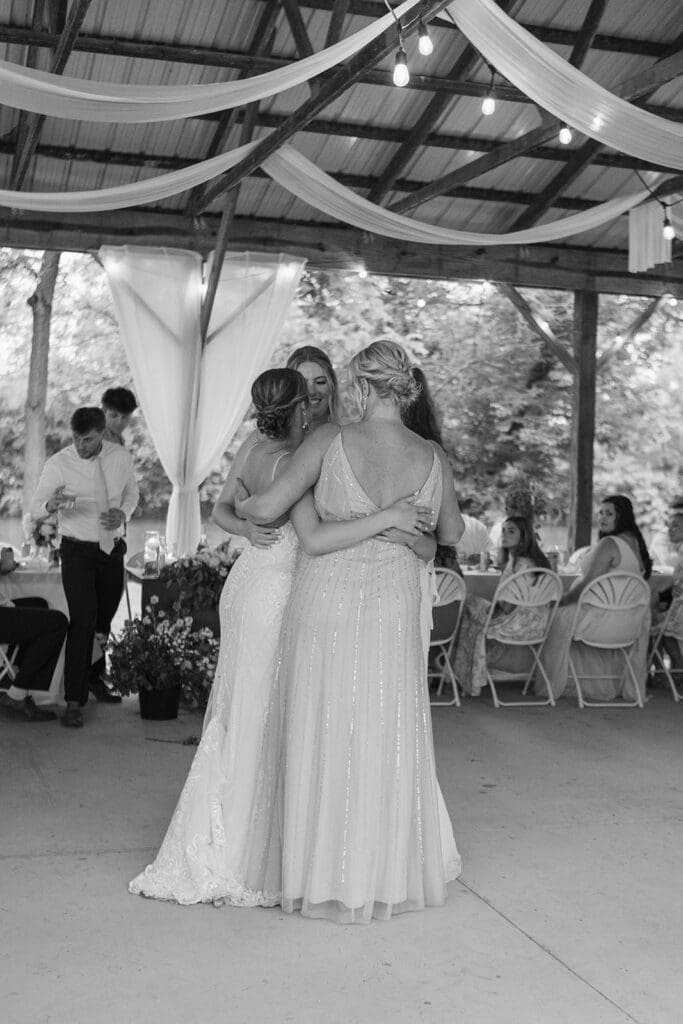 Bride, her sisters, and her mother dance together