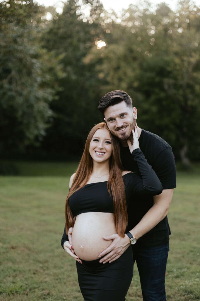 Outdoor maternity portrait of man and woman