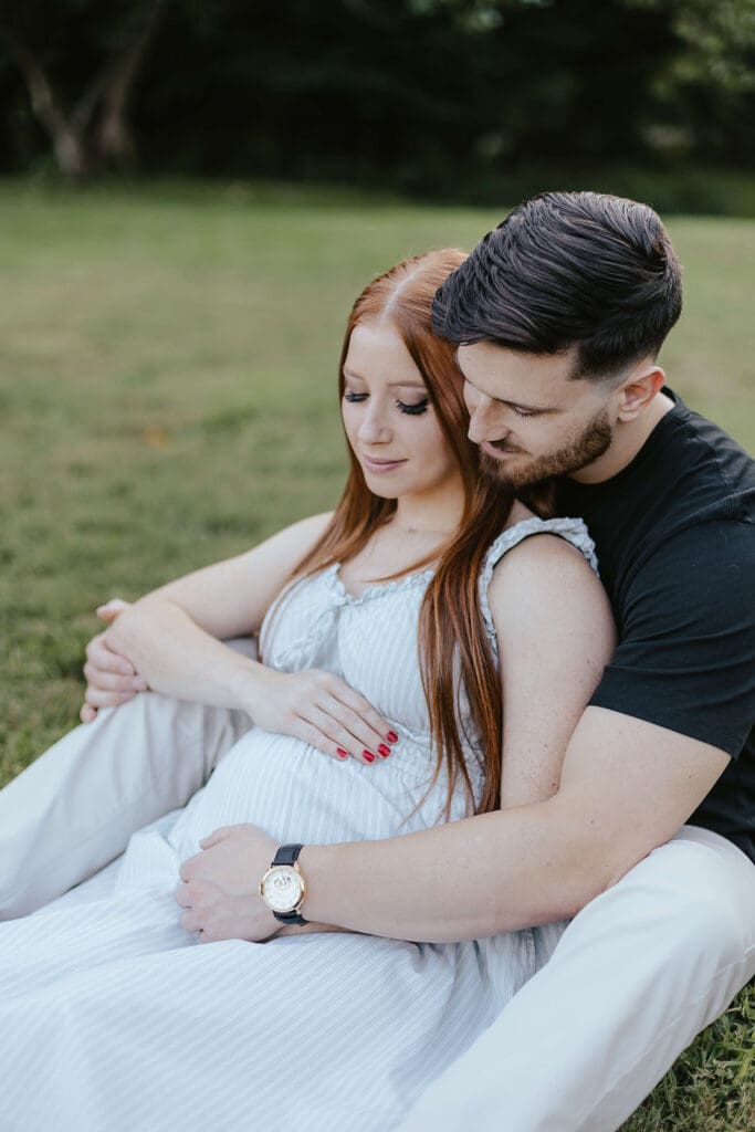 Man and woman touch woman's pregnant belly