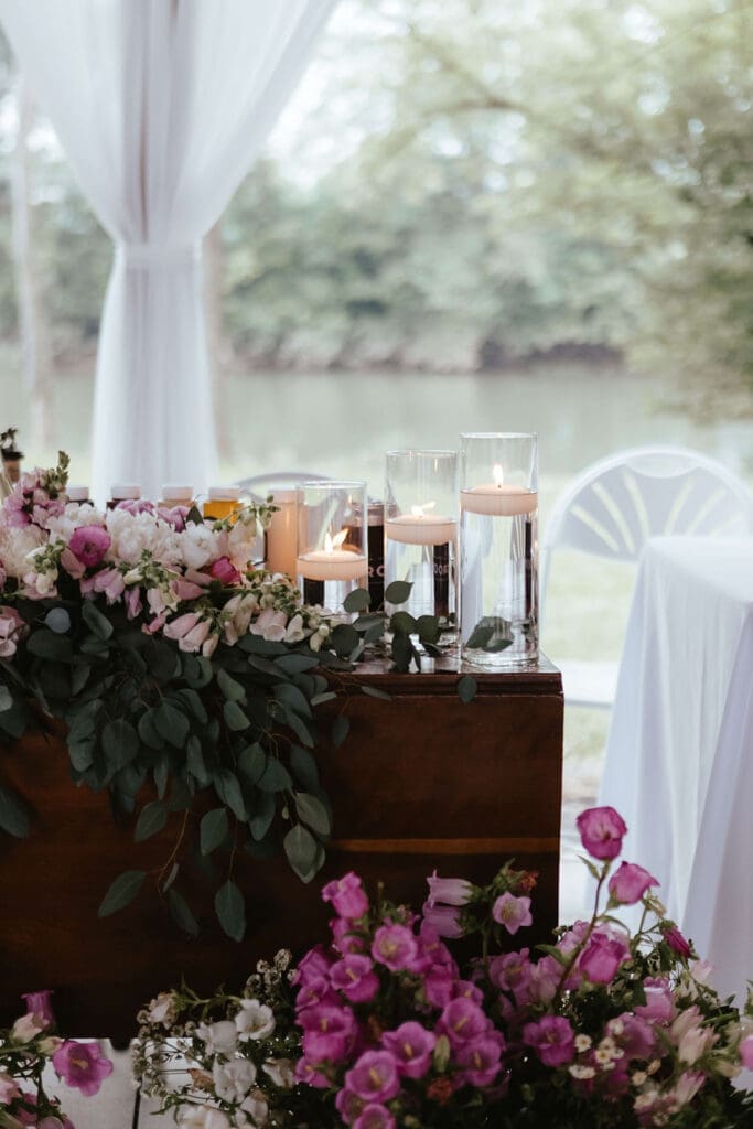 Sweetheart table with magenta and white flowers and floating candles