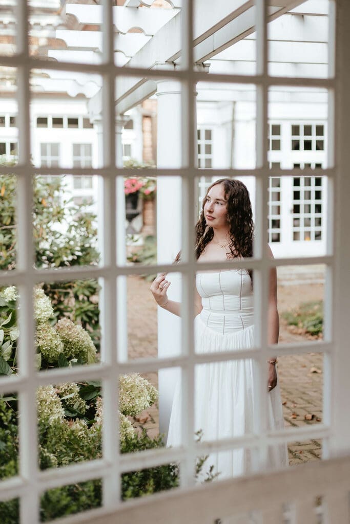 Senior portrait of girl through a lattice at a private residence in Lancaster, Pennsylvania