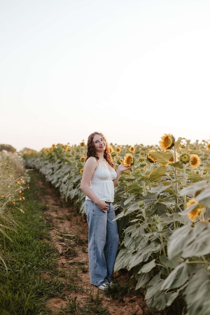 Senior portrait in a field of sunflowers at Wildflower Lookout in Lancaster, PA