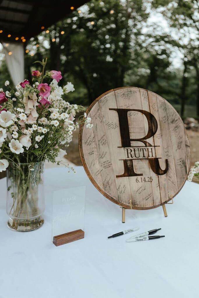 Wooden circle with the name "Ruth" burned into the wood, displayed to act as a guest book