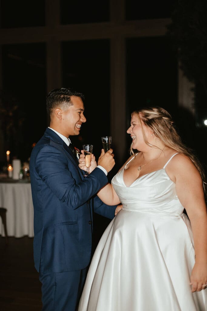 Bride and groom toasting champagne on the dance floor