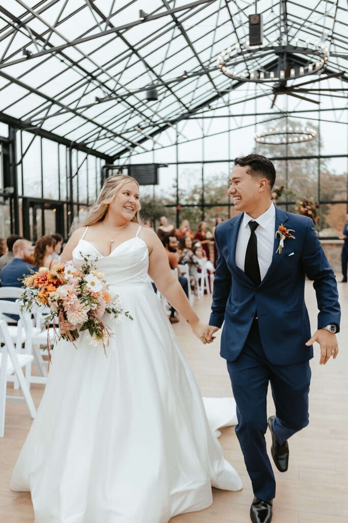 Bride and groom smiling after their ceremony at Westwynd Gardens