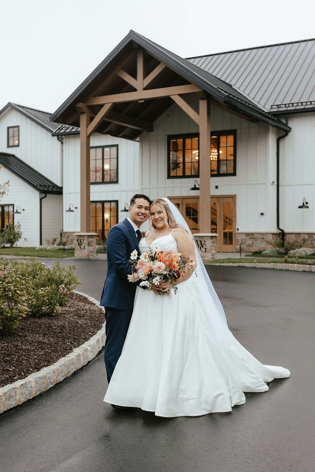 Bride and groom outside Westwynd Gardens in Honey Brook, PA on their rainy fall wedding day