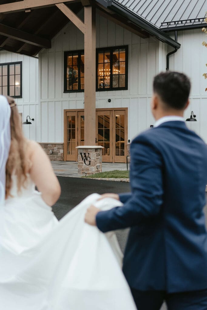 Bride and groom walking into wedding reception at Westwynd Gardens