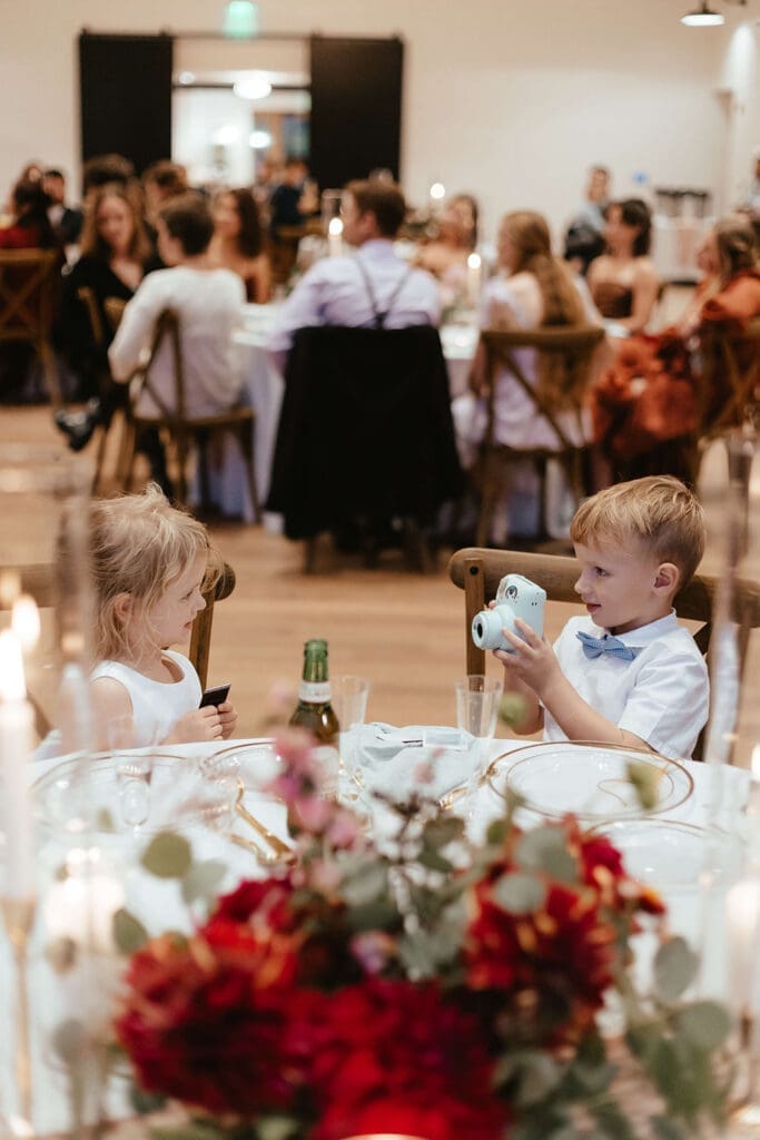 Children taking photos during a wedding reception