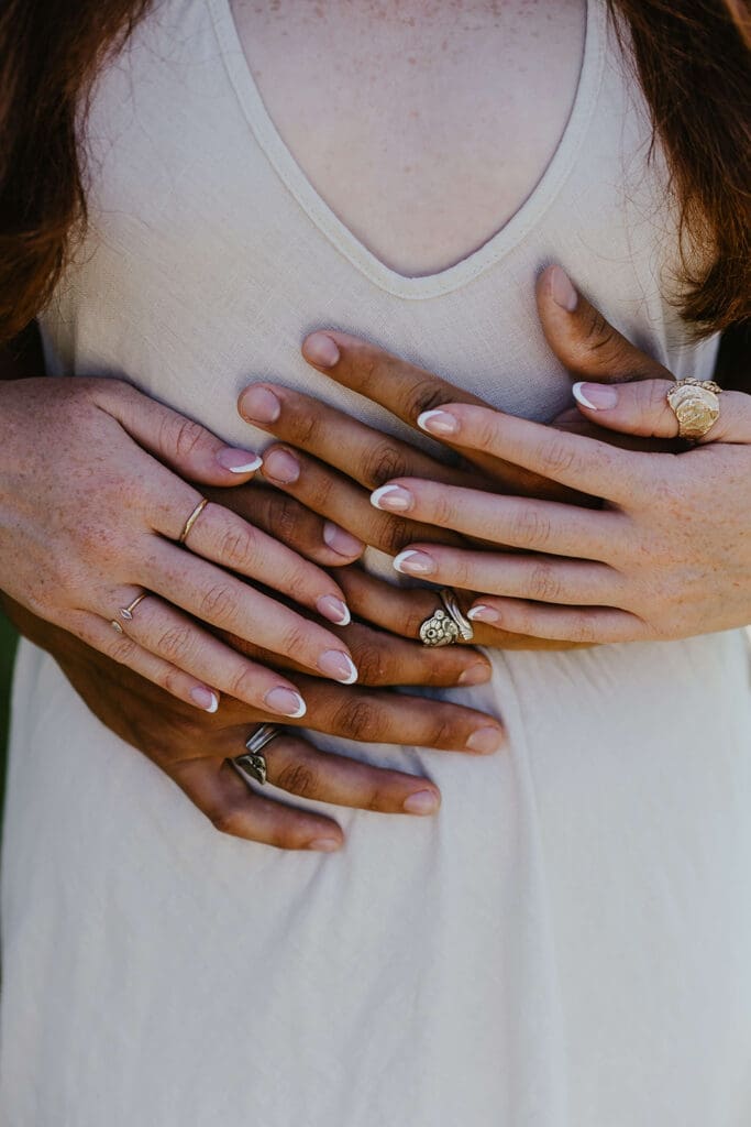 Detail shot of man and woman wearing unique handmade rings