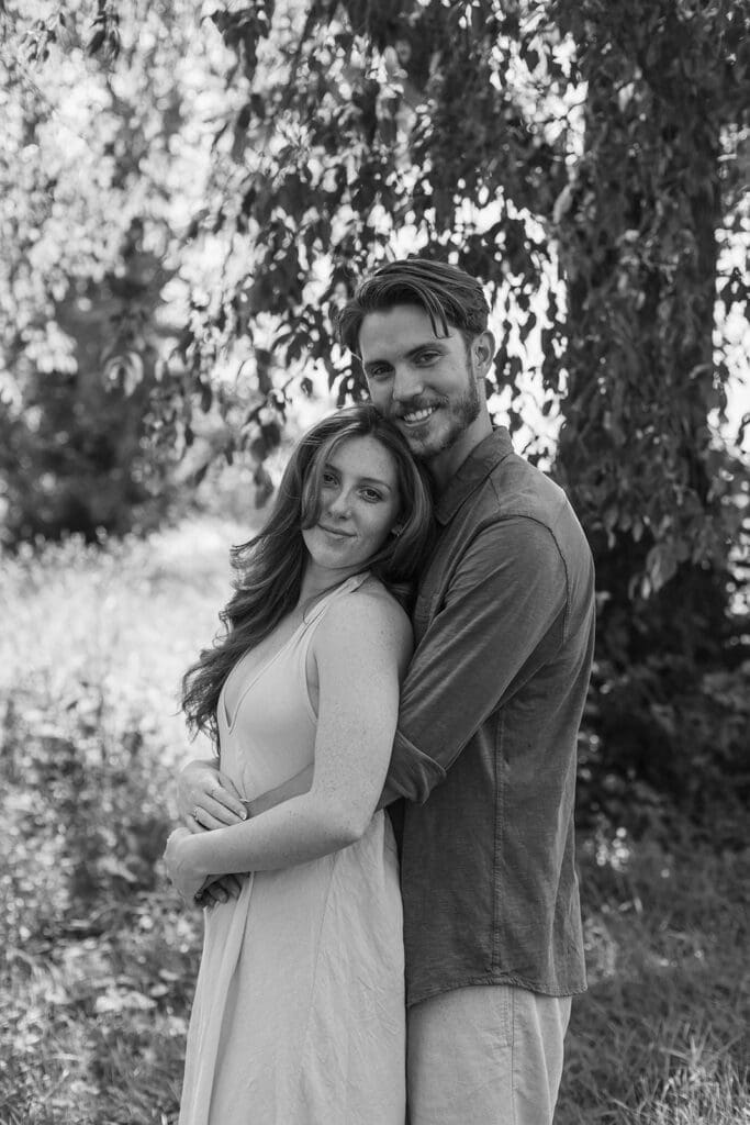 Engagement photo of a man embracing his fiancée