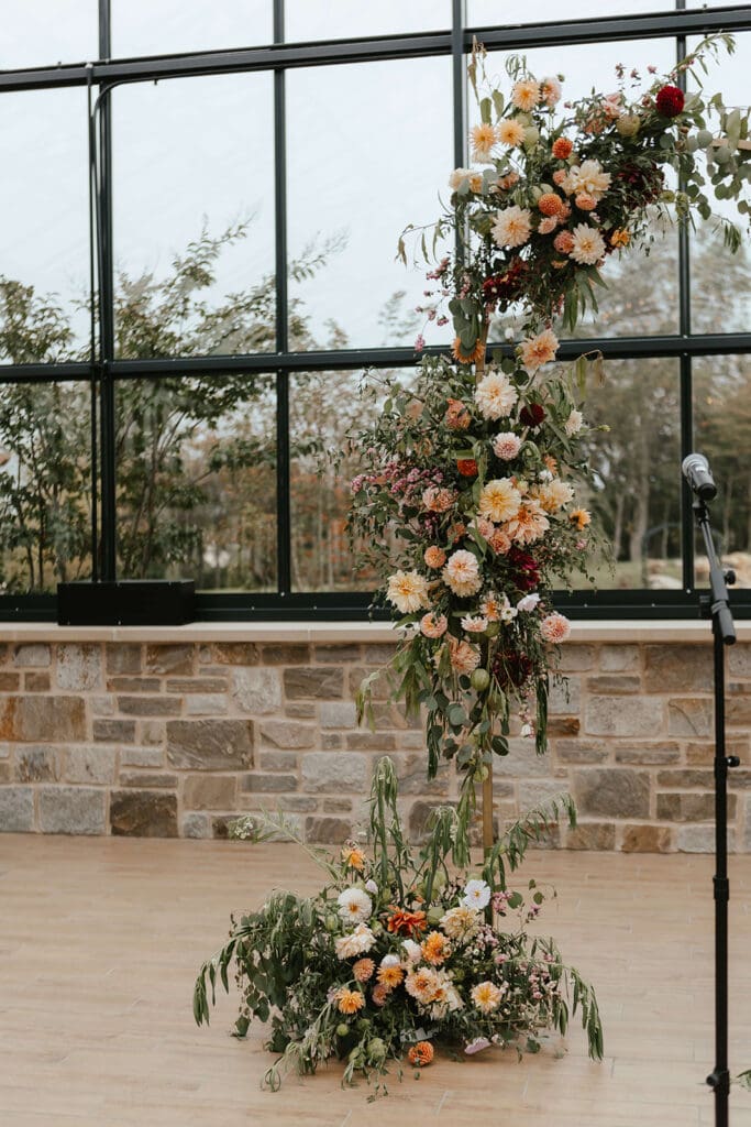 Rustic fall floral arch in the greenhouse at Westwynd Gardens