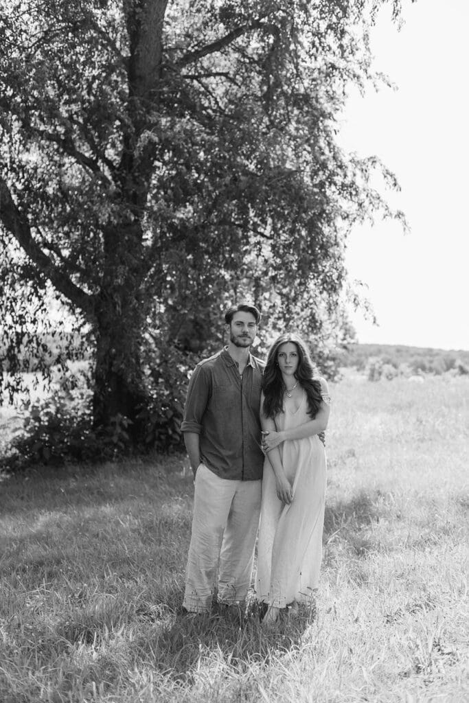 Serious portrait of engaged couple in a field