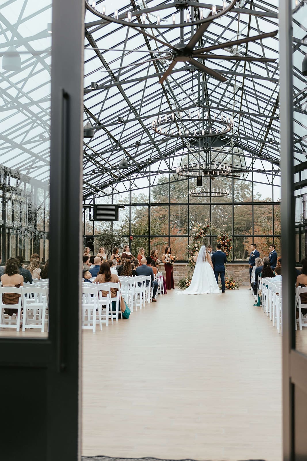 Wedding ceremony in the greenhouse at Westwynd Gardens