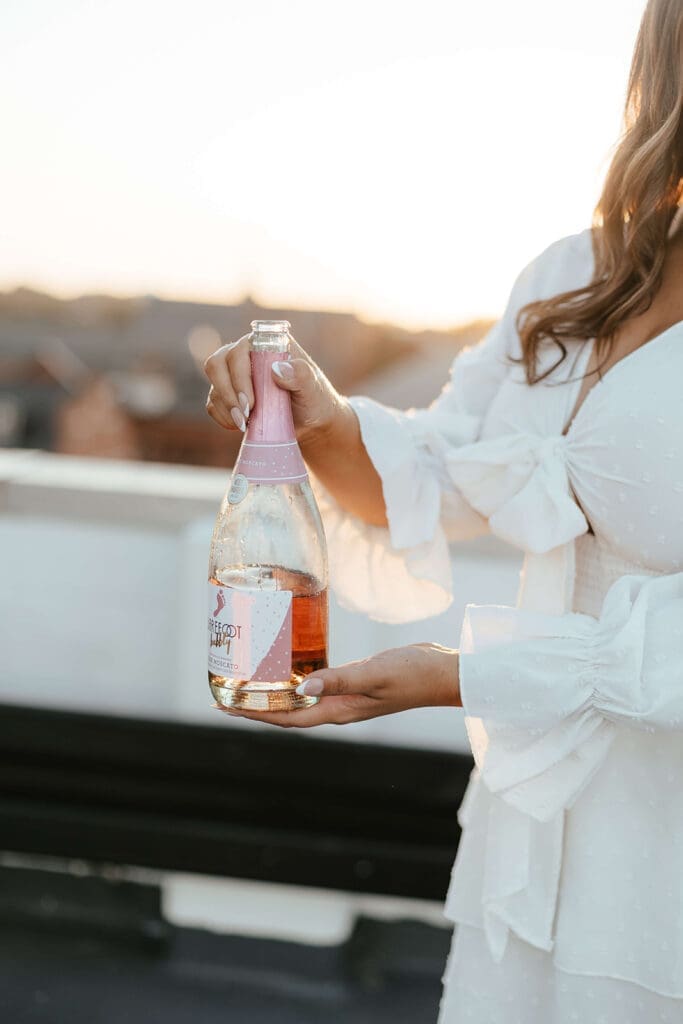 Graduating senior holding a half-empty bottle of champagne