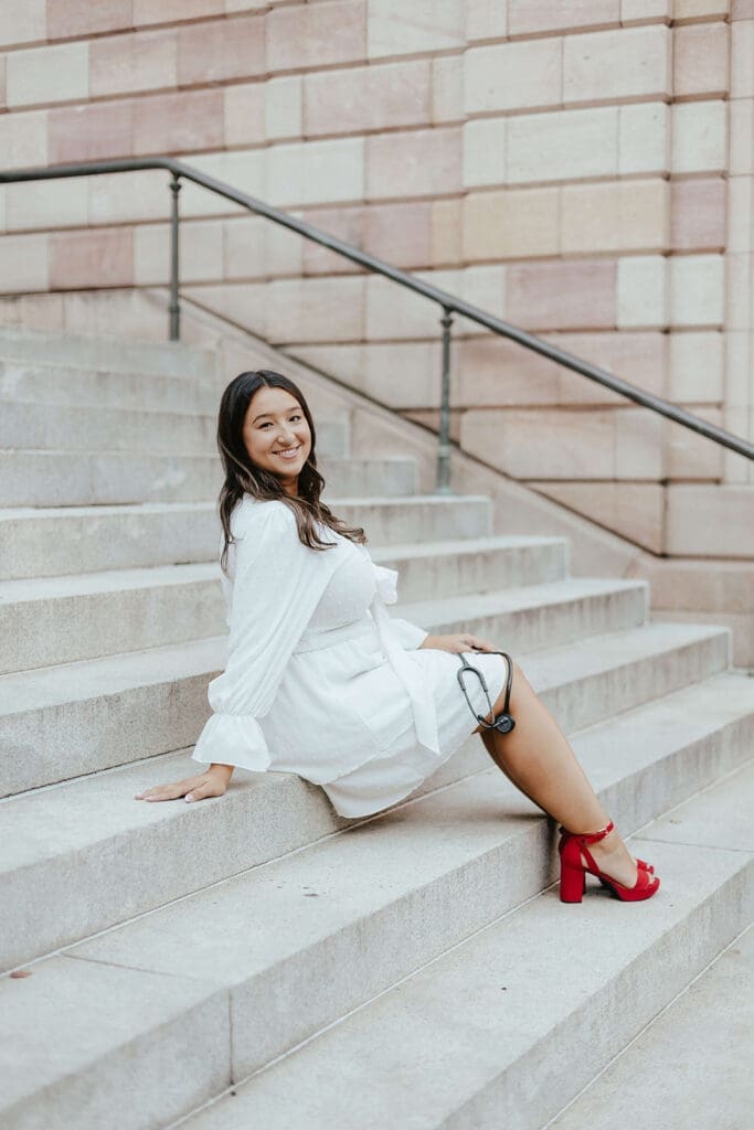 Nursing student college graduation photo on the steps of Lancaster County Courthouse with stethoscope