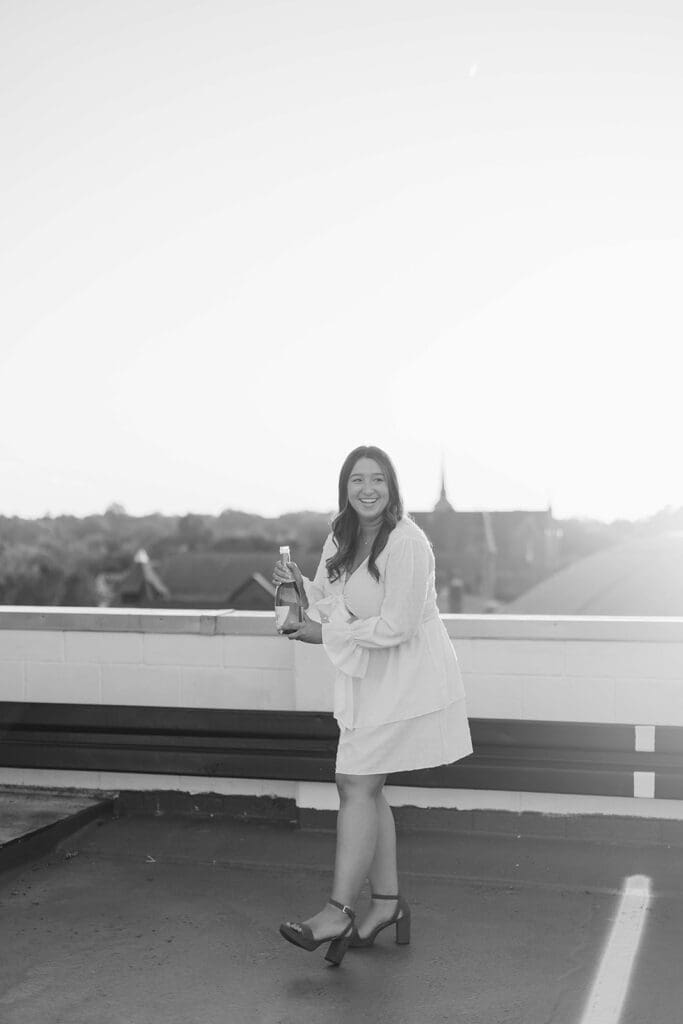 Graduating senior holding a bottle of champagne